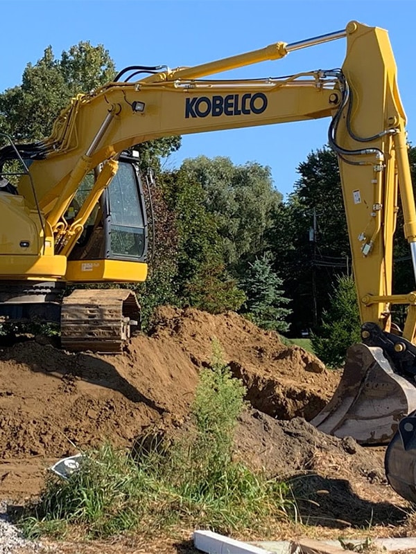 An excavator working on a residential earthwork project
