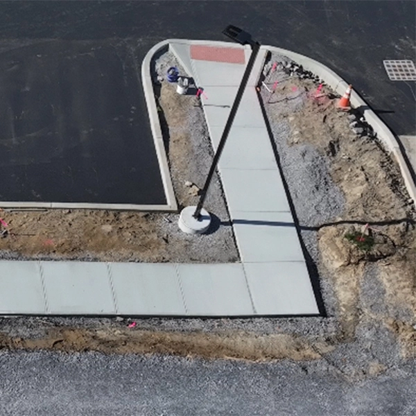 An aerial view of a freshly poured concrete sidewalk.