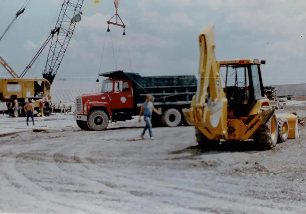A historic photo of an aggregate quarry with construction equipment.
